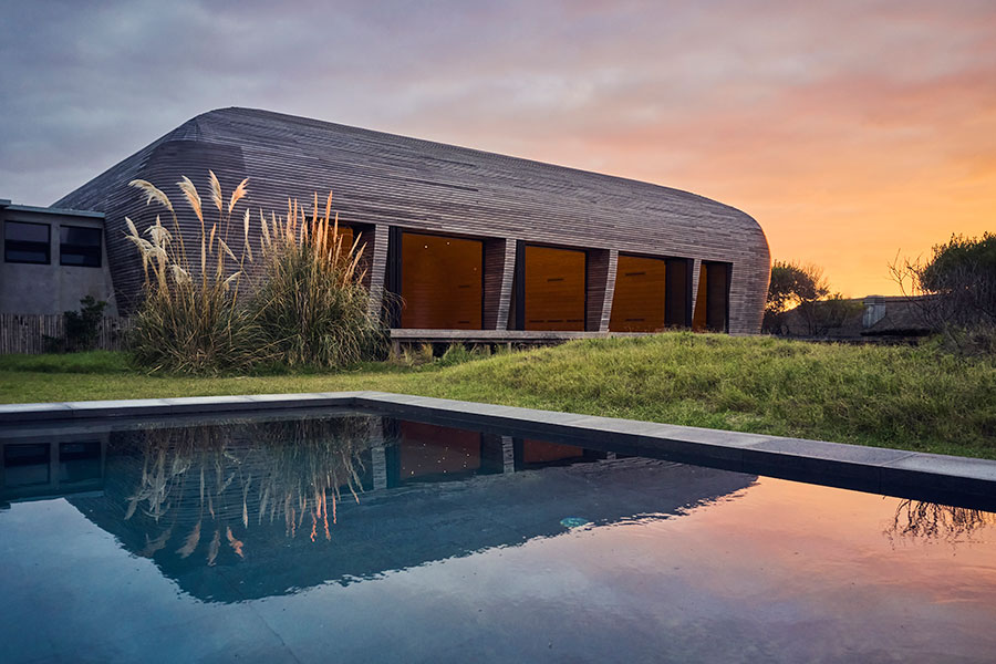 Pavilion Vik at sunset, beside the pool