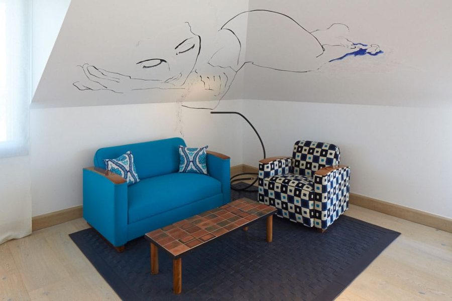 Eva Suite at Bahía Vik: a blue sofa and a drawing on the wall