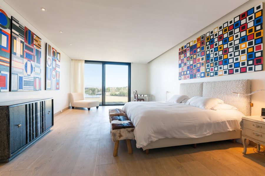 Guerra Suite at Bahía Vik, with a colourful tile mural and a view of the dunes