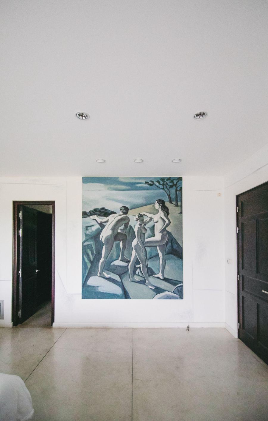 A painting of figures on a white wall in the Trujillo Suite